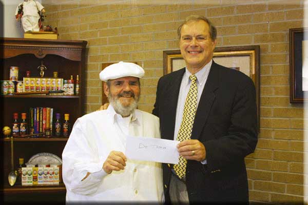 Chef Paul Prudhomme presenting MAD donation to Dr. Jess Thoene